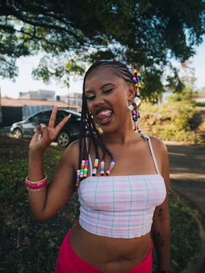 Beaded braids and a peace sign outdoors