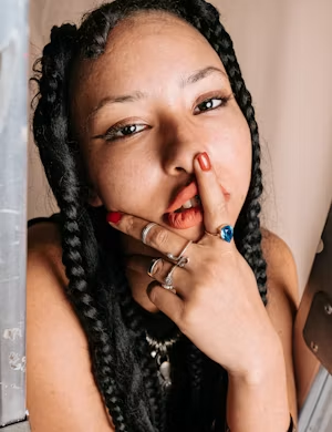Twin braids with rings and red nails