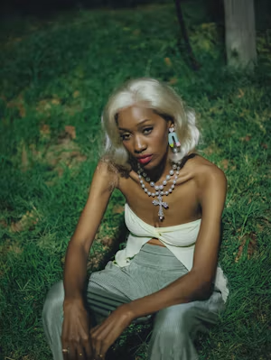 Blonde bob with layered pearl necklaces