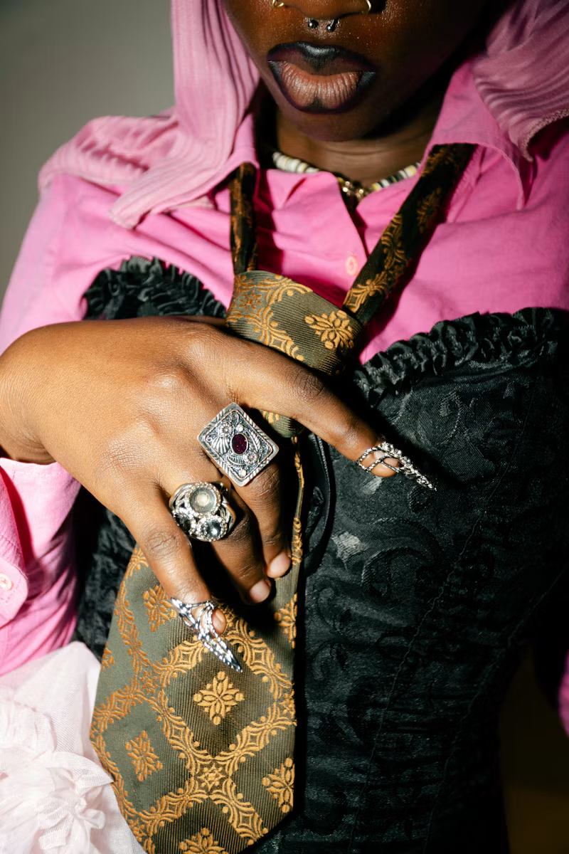 Statement silver rings, pink shirt and patterned tie