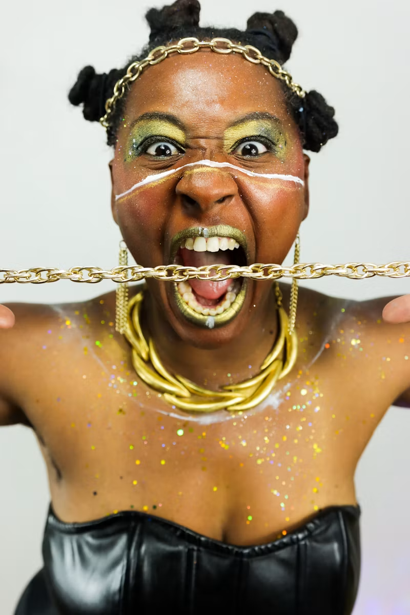 Bantu knots, gold makeup and layered gold chains
