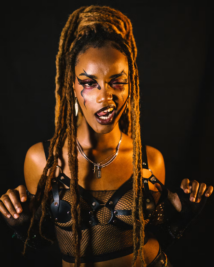 Gold-lit locs, bold eye makeup and layered necklaces