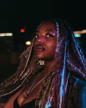 Braided hair and silver jewelry in blue night lighting